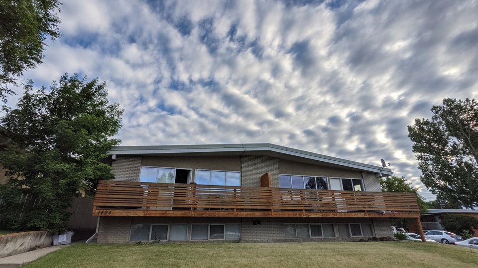 Calgary duplex with cleaned windows and cedar balcony railing
