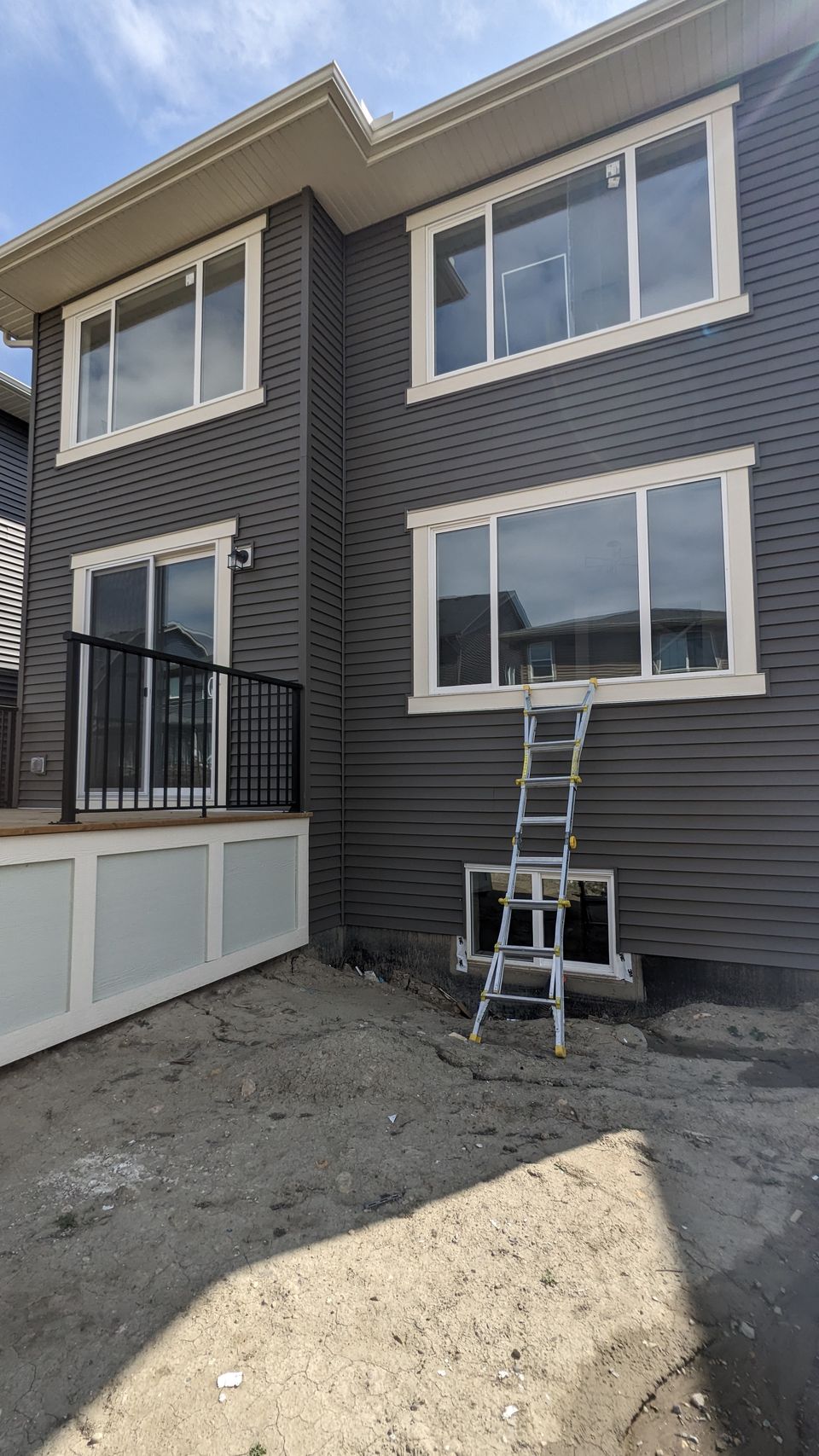 Ladder set for post-construction window cleaning on a new Calgary build