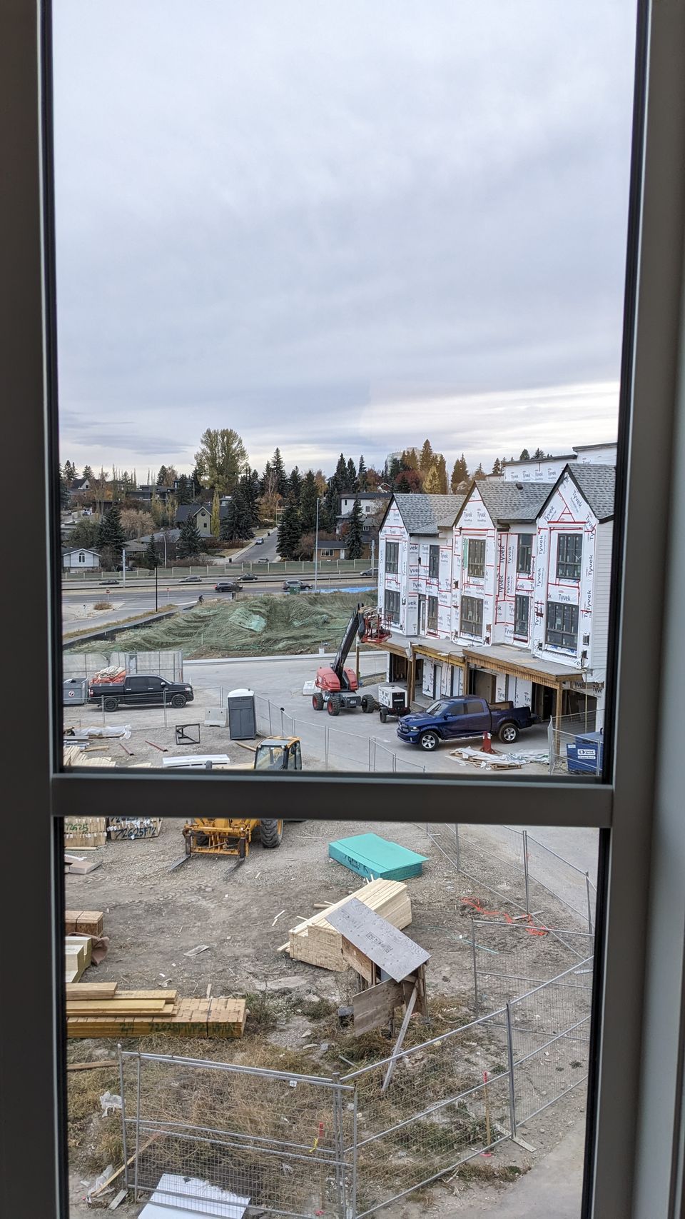 View through freshly cleaned windows over an active Calgary construction site