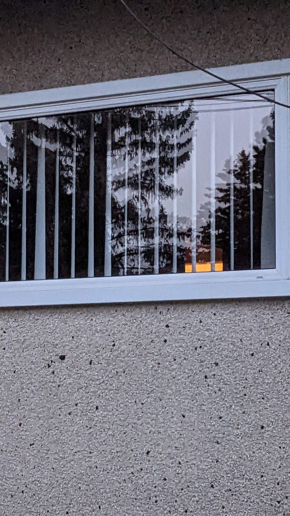Soft-wash brush cleaning siding and windows on a Calgary home